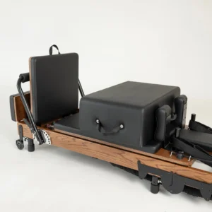 FOLD Reformer Pilates bed in Red Oak and Black PU leather accessories