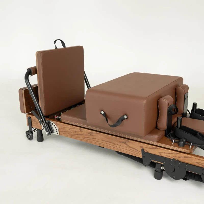 FOLD Reformer Pilates bed in Red Oak and Chocolate PU leather accessories