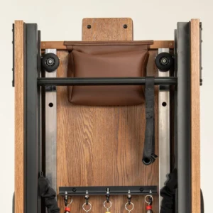 FOLD Reformer Pilates bed in Red Oak and Chocolate PU leather detailed shot