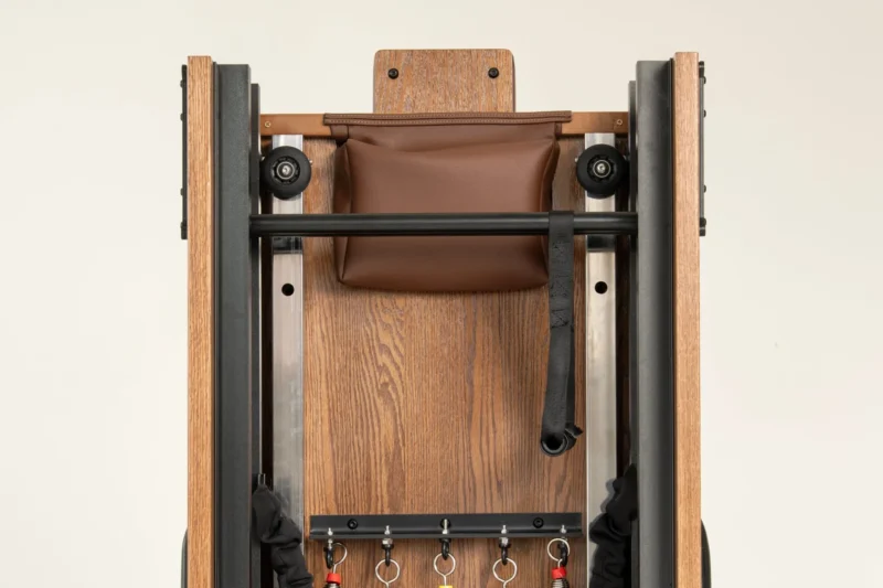 FOLD Reformer Pilates bed in Red Oak and Chocolate PU leather detailed shot