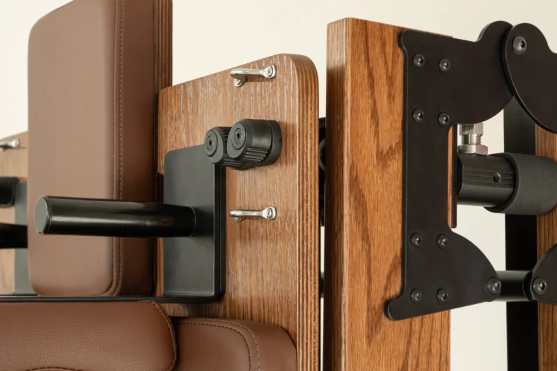 FOLD Reformer Pilates bed in Red Oak and Chocolate PU leather detailed shot