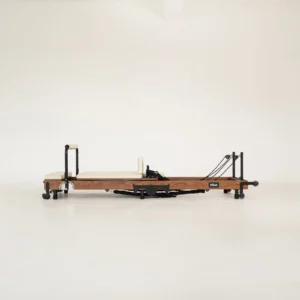 FOLD Reformer Pilates bed in Red Oak and Beige PU leather