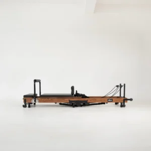 FOLD Reformer Pilates bed in Red Oak and Black PU leather