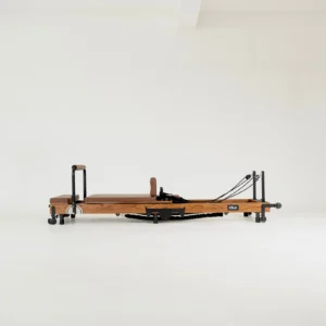 FOLD Reformer Pilates bed in Red Oak and Chocolate PU leather