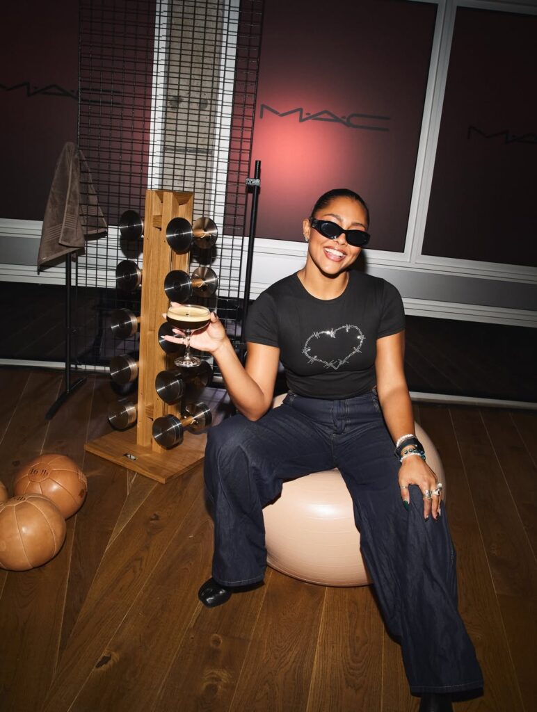 MAC Cosmetics Studio Fix Foundation event with Paragon Studio fitness equipment, showing a dumbbell rack in the background.