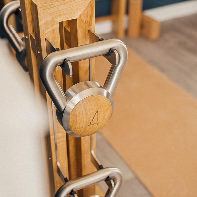 Stainless steel and oak kettlebells on stand